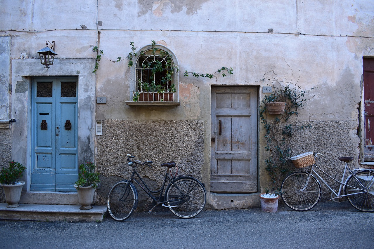 Bicycle hanging from a wall mount in a narrow apartment hallway